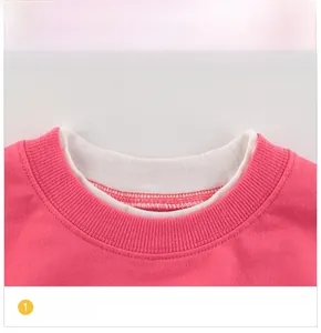 Detail shot of a rose red girl's sweatshirt with white crew neck collar and neat stitching