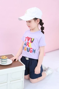 Detail of purple cotton t-shirt with 'You Are Enough' print and navy blue shorts for girls