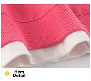 Detail view of pink ribbed hem with white cotton layered bottom on a girl sweatshirt