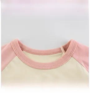 Close-up of pink ribbed neckline and clean stitching on a toddler bear t-shirt