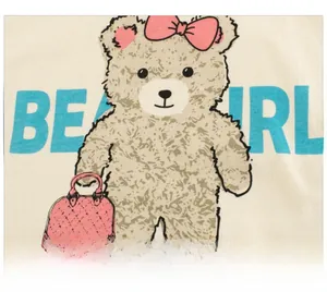 Close-up of cute brown bear cartoon print with Bear Girl text on cream cotton t-shirt