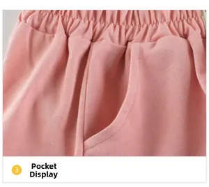 Detailed view of elastic waistband and functional pocket on pink cotton shorts
