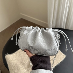 Silver metallic pleated cloud bag with stylish chain strap and drawstring closure