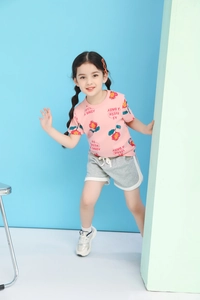 Detail of pink floral t-shirt and grey sporty shorts set for girls summer outfit