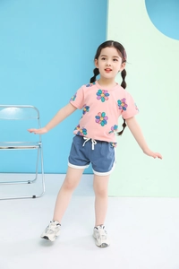 Detail of girls summer set with floral pink t-shirt and blue drawstring shorts