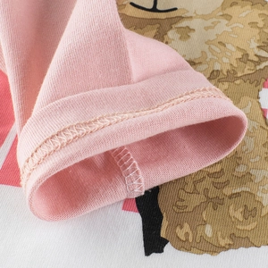 Close-up of pink cotton knit top for girls featuring bear prints and precise stitching