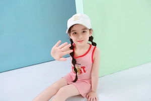 Détail de la robe rose sans manches pour fille avec bord rouge et ours 3D mignon