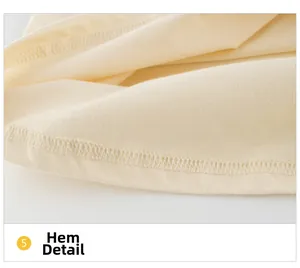 Détail de l'ourlet de robe en coton crème avec couture robuste à double aiguille