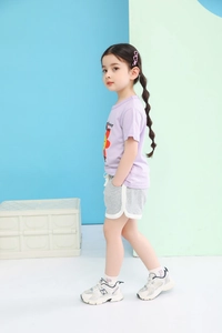 Detail of girls summer casual outfit with lavender sunflower tee and grey active shorts