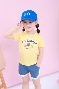 Kids yellow t-shirt and blue athletic shorts set shown on a child model in studio