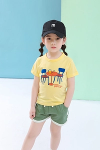 Detail of kids casual summer set with yellow printed t-shirt and green sport shorts
