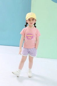 Close-up of pink cotton T-shirt with summer print and purple athletic shorts for girls