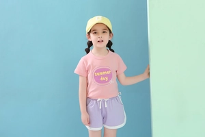Close-up of pink summer t-shirt and light purple shorts set with drawstring detail