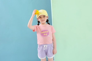 Kids pink summer t-shirt and purple shorts set with a yellow cap on high-quality model view