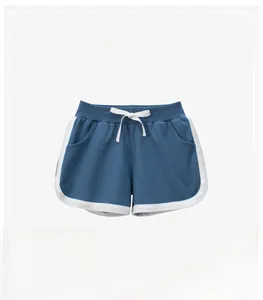 Detail of navy blue kids knit shorts with white contrast piping and drawstring waist