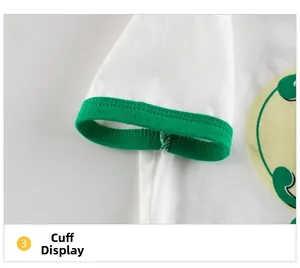 Detail view of cotton T-shirt cuff with green ribbed edging and yellow circular print