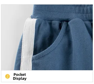 Detail of blue kids' shorts showing side stripes and pocket on soft cotton fabric