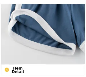 Detail of navy blue knit shorts featuring white piped hem and smooth stitching