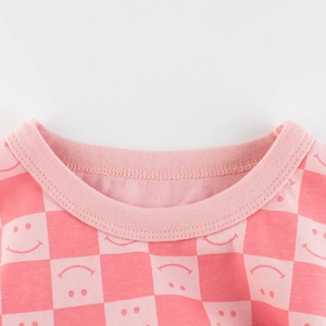 Pink checkered knit t-shirt for girls featuring cute smiley face prints and a round neck