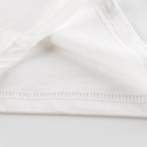 Close-up of white cotton kids T-shirt showing premium double-needle stitching on the hem
