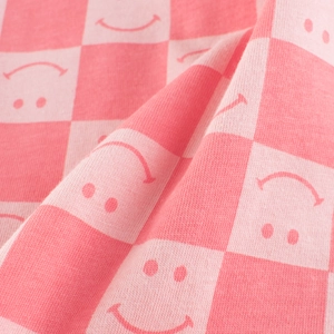 Pink checkered knit kids t-shirt featuring cute smiley face print details