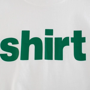 White cotton t-shirt for kids featuring a vibrant green shirt text print on the chest