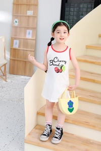 Detail of white cotton girls' cherry print sleeveless dress with red contrast edging