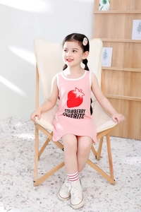 Detail of girls' summer cotton dress showing strawberry print and soft pink fabric