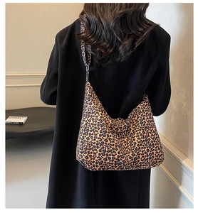 Rear view of a large leopard print canvas tote bag styled as a minimalist shoulder bag