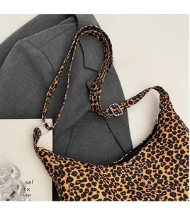 Detail of leopard print tote bag with adjustable strap on a minimalist urban background