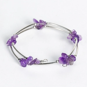 Double-layer silver wire bracelet with natural purple crystal stones on white background
