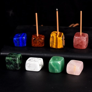 Natural crystal cube incense burner base with multiple gemstone textures on dark background