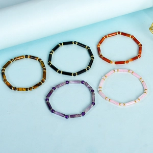 Five-piece beaded bracelet set featuring colorful stones and metallic accents