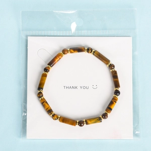 Tiger eye stone beaded bracelet with cylindrical and round beads on a display card