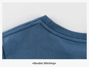 Detailed close-up of double-needle chain stitch on a blue cotton boy's t-shirt neckline