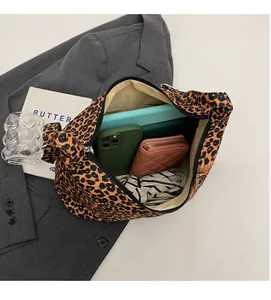 Detailed interior view of a leopard print tote bag showing large capacity and compartments