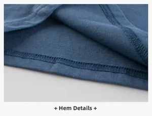 Detailed close-up of double-needle stitching on blue cotton t-shirt bottom hem