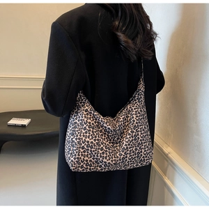 Detailed view of oversized leopard print tote bag styled as a chic shoulder crossbody bag