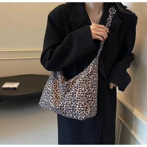 Close-up of leopard print canvas tote bag with adjustable shoulder strap and slouchy design