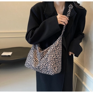 Detail of adjustable strap and silver metal buckle on the leopard print canvas tote bag