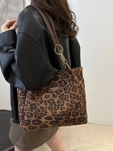 Retro leopard print tote bag with brown straps and gold ring hardware on a model
