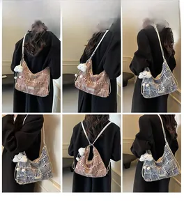 Detail view of canvas tote bag with geometric patterns and plush cloud keychain accessory