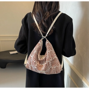 Minimalist canvas tote bag with brown geometric patterns and white leather straps
