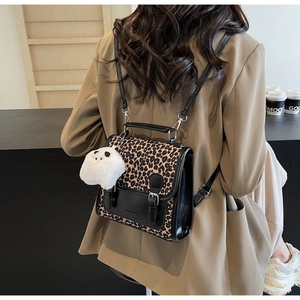 Leopard print crossbody backpack with a cute panda plush charm on a tan blazer outfit