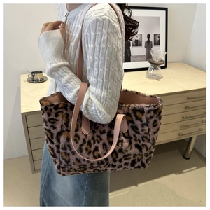 Pink leopard print plush tote bag showing soft faux fur texture and side profile on shoulder