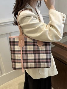 Stylish pink plaid tote bag for women with long handles shown on a model in a natural setting