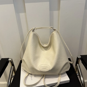 Minimalist beige PU leather large tote bag on a chair with natural soft texture