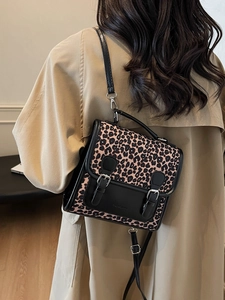 Stylish leopard print crossbody backpack for women with black leather details and metal buckles