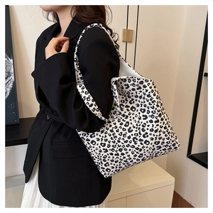 Large leopard print canvas tote bag shown on shoulder for daily commute style