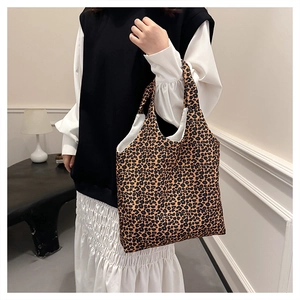 Detail view of canvas leopard print tote bag interior and soft fabric texture for commuting